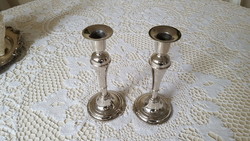 A pair of graceful, silver-colored candle holders
