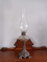 Old kerosene lamp on a lion's claw base