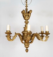 Gilded bronze chandelier decorated with plastic heads