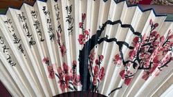Old Japanese paper fan with cherry blossoms