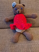 Knitted teddy bear doll in red clothes