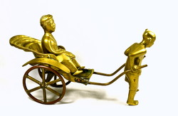 Oriental rickshaw with passenger ... Copper statue!