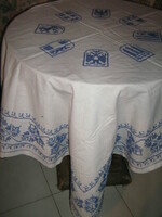 Beautiful antique hand-embroidered tablecloth with blue leaves