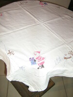 Beautiful cross-stitch hand-embroidered white winter tablecloth with Santa Claus