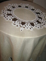 A huge festive tablecloth in cream color with a fabulous hand-crocheted flower insert