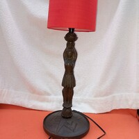 Carved wooden, human-shaped table or bedside lamp. It works.