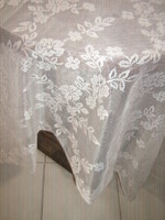 A pair of light floral curtains with beautiful wavy edges