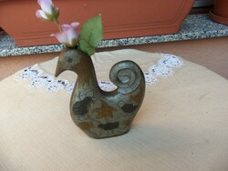 Ornament of a bird holding a flower
