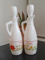 A pair of milk bottles holding oil and vinegar