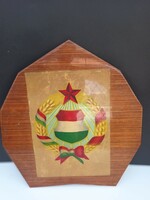 Socialist coat of arms on a wooden carrier