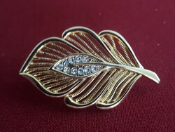 Gold-colored brooch decorated with tiny stones