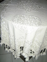 Beautiful elegant woven tablecloth with sewn-on writing and pom-pom fringes