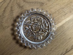 Rose flower in small glass plate, ashtray?