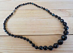 Faceted growing eye black glass bead necklace