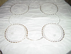 A dreamy white embroidered tablecloth with a hand-crochet insert