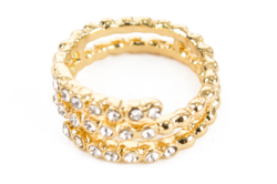 A spiral ring with many zirconia stones is gold-colored, a special piece of jewelry.