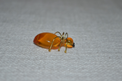 Spider brooch with amber effect