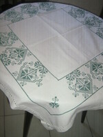 Woven tablecloth embroidered with beautiful green cross stitches