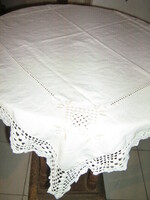 Beautiful azure hand-embroidered antique beige tablecloth with crocheted edges