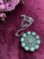 A wonderful turquoise pendant on a chain made of pearls