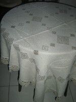 Beautiful antique hand-embroidered woven tablecloth with cross-stitch crocheted edges