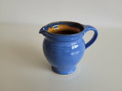 Glazed ceramic jug with blue small spout