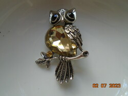 Polished, silver-plated owl brooch with faceted stones
