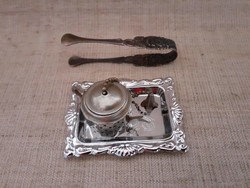 Retro teapot-shaped tea egg on a small patterned metal tray with rose-patterned sugar tongs