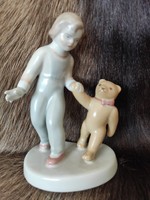Porcelain statue of a little girl with a teddy bear