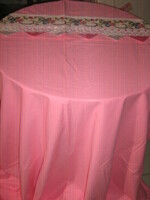A beautiful pink quilt cover with a cross-stitched flower insert