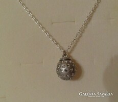 Silver-colored spherical pendant richly studded with zirconia stones, very showy.