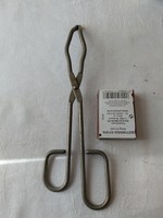 Medical instrument surgical? Tool clamps or tweezers or something like that...