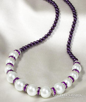 White and purple elegant jewelry set with purple crystal decoration. Necklace and bracelet.