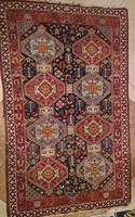 Antique oriental carpet with animal and religious symbols.