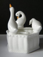 Geese in a basket with porcelain candlesticks