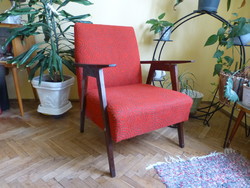 Red armchair with retro wooden armrests, mid century design armchair,