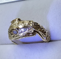 Snake head women's gold ring with diamond eyes.