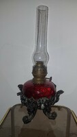 Antique kerosene lamp in crimson color with a larger glass container