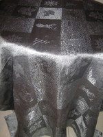 Elegant light festive tablecloth with a beautiful Christmas pattern in silvery graphite gray color
