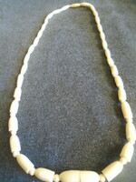 Old, exotic bone art deco necklace. African handcrafted jewelry from the 1960s in mature egg color