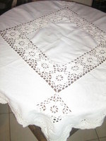 White tablecloth with a beautiful hand-crocheted edge and flower insert