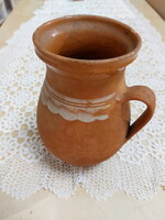 An old mug, a glazed earthenware pot, a jar, a jug, a tumbler