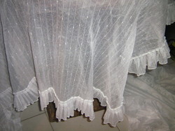 A beautiful pair of special densely ruffled curtains with rounded corners