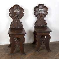 Pair of carved wooden chairs - with stylized plant decor