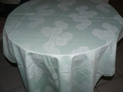 Beautiful pale green damask tablecloth with white flowers