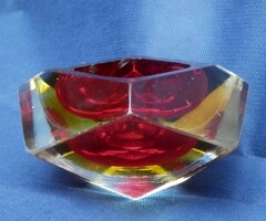 A multi-colored decorative object inlaid on a crystal sheet