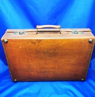 Antique genuine leather suitcase with toiletries