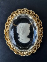 Vintage female head plastic badge, brooch, in a metal frame, jewels