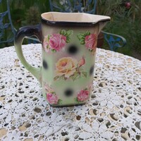 Antique earthenware jug with flowers