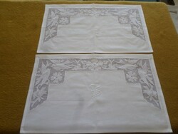 Snow-white embroidered, azure, bird-like, monogrammed shelf cover.
